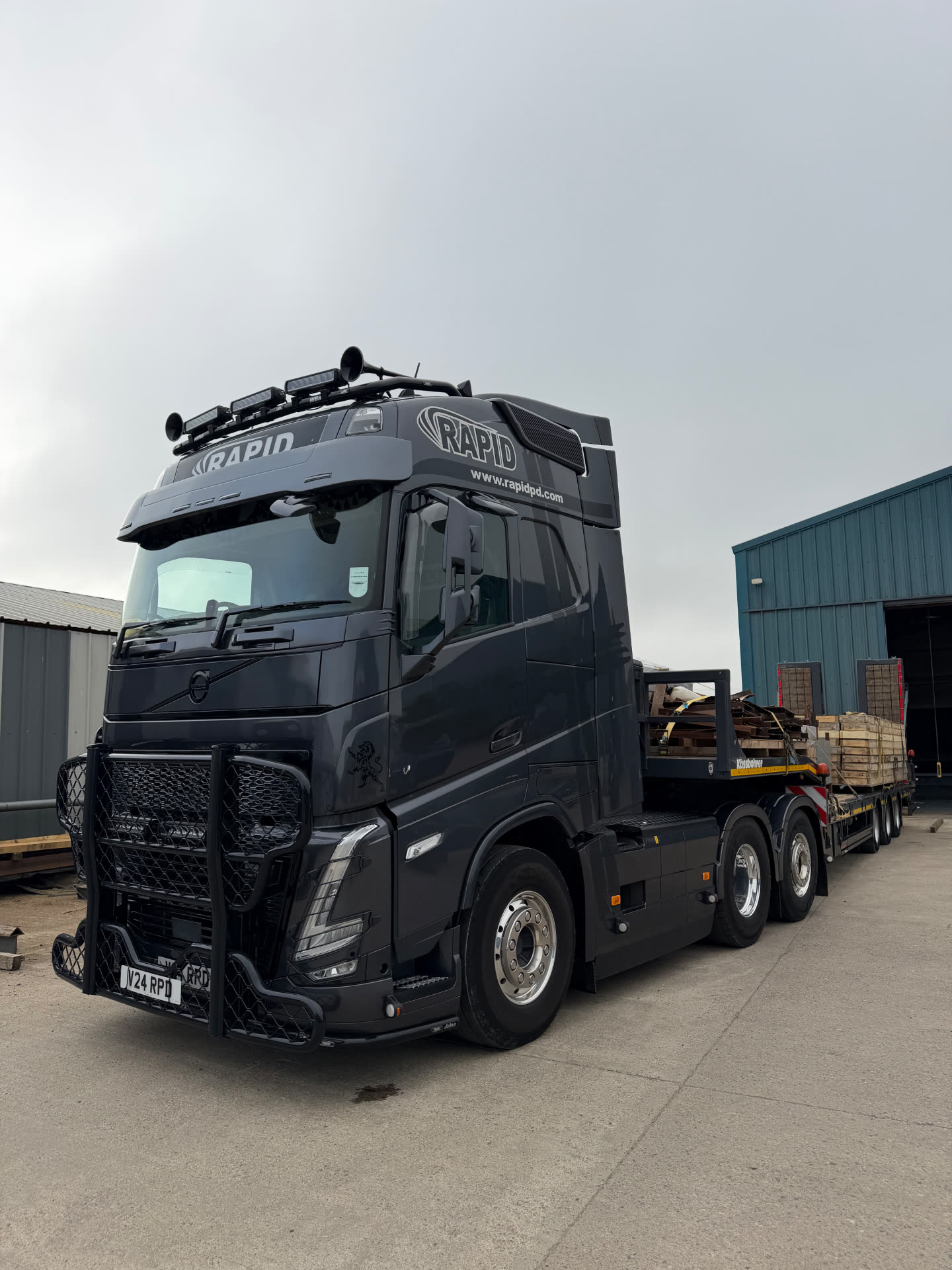 RPD truck and low loader loaded with fabricated steel outside the workshop
